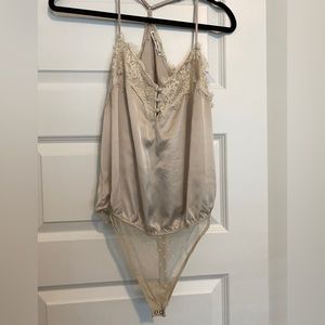 cream colored silky lace bodysuit